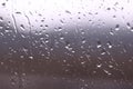 Drops of water on window glass after rain with dramatic blurred sunset on background. Idyllic tranquil nature wallpaper