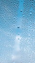 Drops water on window for mobile wallpaper design. Blue cloudy sky backdrop. Spotted abstract texture background. Spring Royalty Free Stock Photo