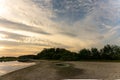 Drought and climate change, landscape of cracked earth with orange sky after lake has dried up in summer. Water crisis an impact Royalty Free Stock Photo