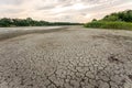 Drought and climate change, landscape of cracked earth with orange sky after lake has dried up in summer. Water crisis an impact Royalty Free Stock Photo