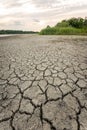 Drought and climate change, landscape of cracked earth with orange sky after lake has dried up in summer. Water crisis an impact Royalty Free Stock Photo