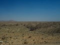 Drought rock desert valley panorama landscape view looking like Mars surface scene with blue sky background Royalty Free Stock Photo