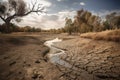 drought-stricken landscape with dried up river and cracked earth Royalty Free Stock Photo