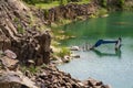 Drowned in flooded basalt quarry excavator Royalty Free Stock Photo