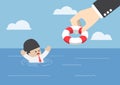 Drowning businessman getting lifebuoy from big hand Royalty Free Stock Photo