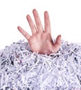 Drowning in destroyed documents. Studio shot of a womans hand reaching out from under a pile of shredded paper against a