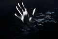 Horror background. Hand reaching out from water