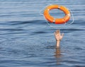 Drowning man with raised hand getting lifebelt in sea, closeup Royalty Free Stock Photo