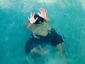 Drowning man in sea asking for help with raised his arms. Safety concept Royalty Free Stock Photo