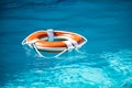 Drowning in water catch lifebuoy. Safety and urgent help. Resque needed. Life buoy floating in pool.