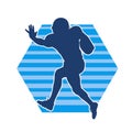 Silhouette of a male american football athlete in action pose. Royalty Free Stock Photo