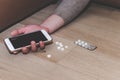 Drug abuse or poison pills concept. Hand on floor, pills. Suicide by overdosing on medication and addict Royalty Free Stock Photo