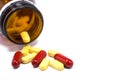 Drug bottle pouring out medicine pills or vitamin isolated. Royalty Free Stock Photo