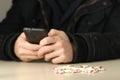 Drug dealer with ecstasy pills calls customers Royalty Free Stock Photo