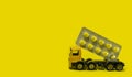 Drug delivery against coronavirus, covid19, concept of medical rescue of the world from virus to man, yellow truck delivers
