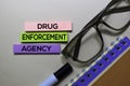 Drug Enforcement Agency - DEA text on sticky notes on office desk