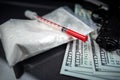 drug heroin lies next to syringes, money dollars weapons isolated on a dark background. Royalty Free Stock Photo