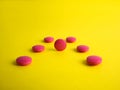 Drug. Round red tablets on a yellow background. Medicine, pharmaceuticals Royalty Free Stock Photo