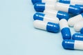 Drugs pills capsules on blue background copy space