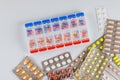 Drugs used for treatment are weekly organizer dispensers for tablets, capsules, a blister packs of medicines Royalty Free Stock Photo