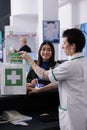 Drugstore worker putting vitamin in customer shopping bag Royalty Free Stock Photo