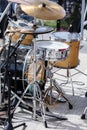 Drum kit with microphones standing on outdoor stage