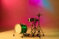 Drum kit or set isolated on multicolored background in neon light