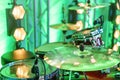 Drum kit on stage. Close-up of plate, drums, sticks, in background scene spotlights Royalty Free Stock Photo