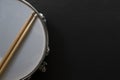 Drum stick and drum on black table background