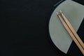 Drum stick and drum pad on black table background, top view, music concept Royalty Free Stock Photo