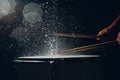 Drum sticks drumming beat rhythm on drum surface with splash water drops Royalty Free Stock Photo