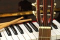 Drum sticks, guitar and piano keyboard