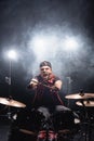 Drummer with crossed drumsticks looking at Royalty Free Stock Photo