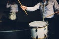 Drummer.The guy holding the drumsticks in his hand.Young man with drumsticks.A bearded man holding a stick in his hands