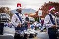 A drummer playing Christmas music in a Christmas parade