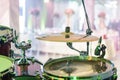 Drum kit on stage. Close-up of plate, drums, sticks, in background scene spotlights Royalty Free Stock Photo