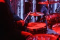 Drummer playing on drum kit on stage. Close-up of plate, drums, sticks, in background scene spotlights Royalty Free Stock Photo