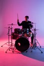 Young man drummer playing on drums on music concert. Club lights, artist show Royalty Free Stock Photo