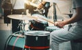 A drummer plays sticks on a drum kit, setting the rhythm to a street band of musicians Royalty Free Stock Photo