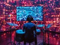 A drummer practicing in a virtual reality setup, with sensors tracking his movements and a large virtual screen in front