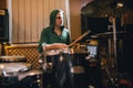 Drummer rehearsing on drums in recording studio