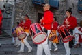 Drummers in red uniform march playing in street during annual celebration of Festa dei Ceri