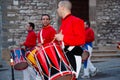 Drummers in red uniform march playing in street during annual celebration of Festa dei Ceri