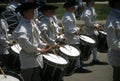 Drummers in white colonial uniforms march Royalty Free Stock Photo