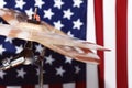 Drums, cymbals, against the backdrop of the American flag