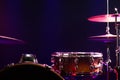 Drums and drum set. Beautiful blue and red background, with rays of light. Beautiful special effects of smoke and lighting Royalty Free Stock Photo