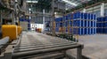 Drums holding 200 liters of chemicals are filled on a line. Inside the warehouse, stacks of blue barrel chemical barrels are Royalty Free Stock Photo