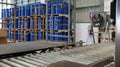 Drums holding 200 liters of chemicals are filled on a line. Inside the warehouse, stacks of blue barrel chemical barrels are Royalty Free Stock Photo