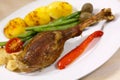 Drumstick of baked Goose with green beans,potatoes