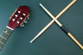 Drumsticks and guitar headstock close up. acoustic musical instrument